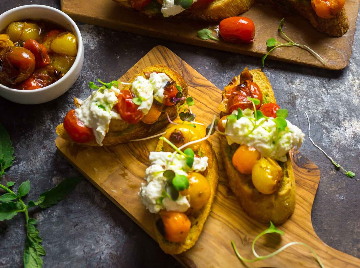 Crostini With Blistered Cherry Tomatoes, Burrata and Chive Oil